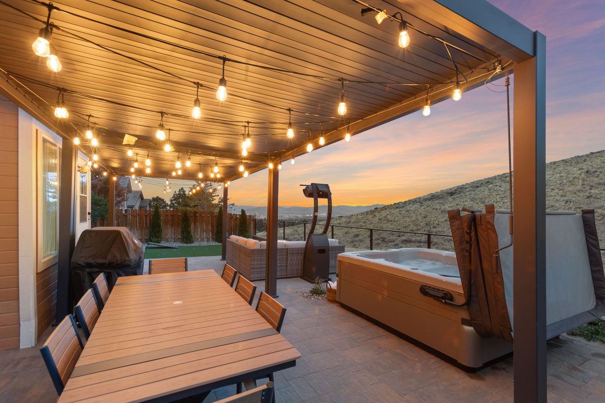 Covered patio with string lights and dining for 10
