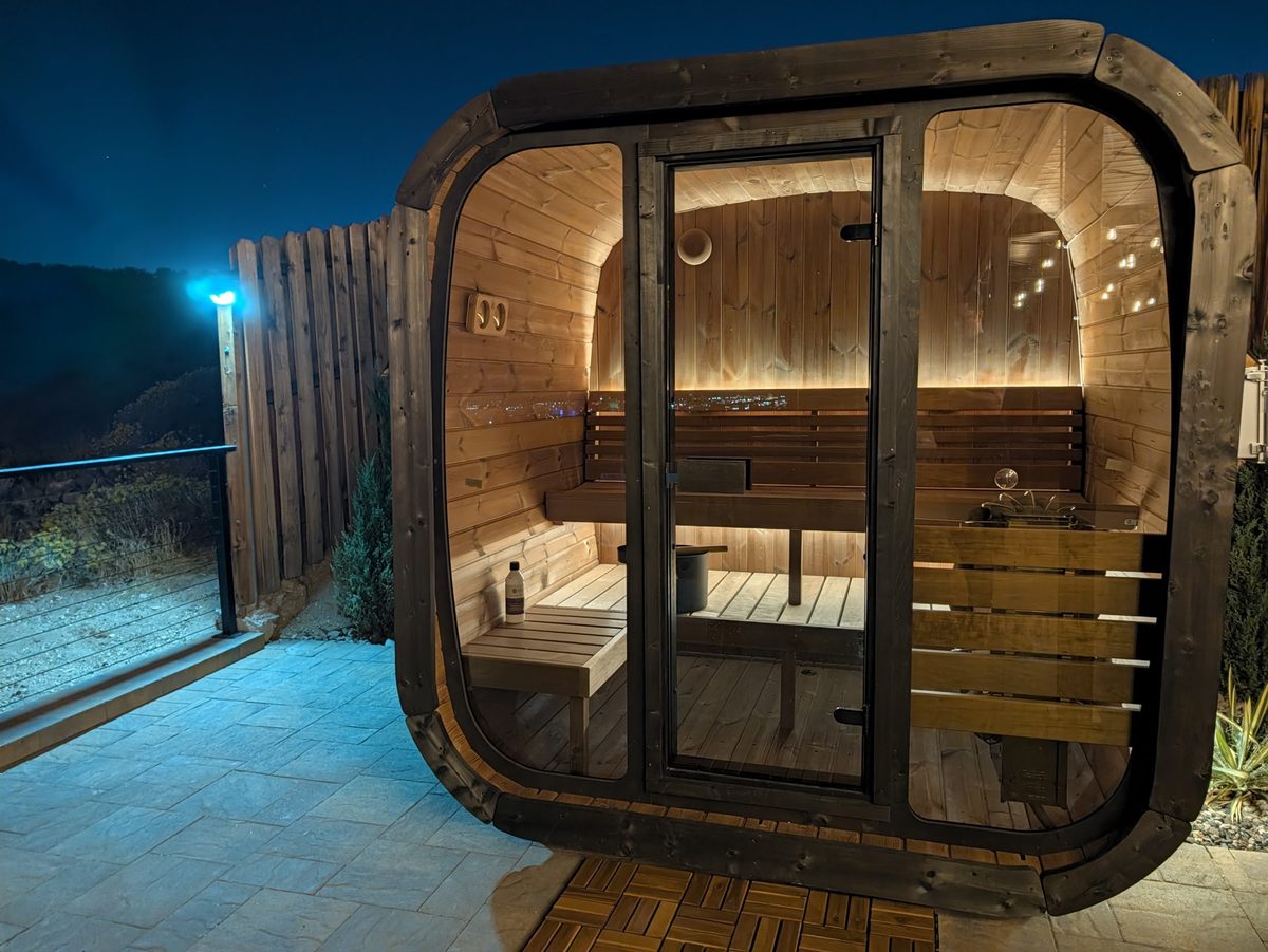 Finnish barrel sauna lit up at night